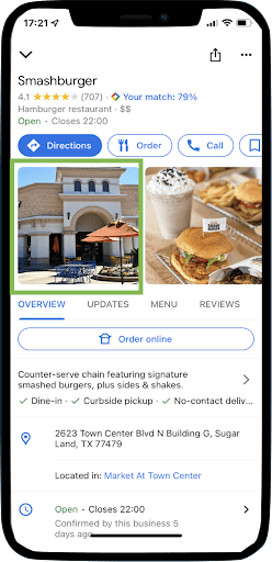 A cell phone highlighting an image of one of Smashburger's photos on its local listing